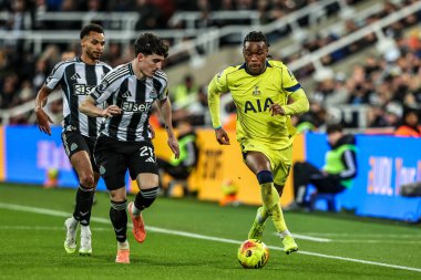Tino Livramento of Newcastle United and Destiny Udogie of Tottenham Hotspur battle for the ball during the Premier League match Newcastle United vs Tottenham Hotspur at St. James's Park, Newcastle, United Kingdom, 2nd December 2025 
