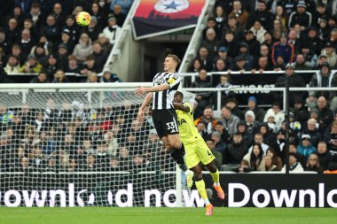 Dan Burn of Newcastle United jumps up to win the high ball during the Premier League match Newcastle United vs Tottenham Hotspur at St. James's Park, Newcastle, United Kingdom, 2nd December 2025 