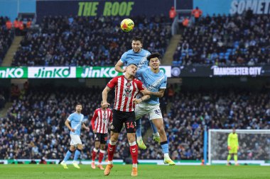 Nico Gonzalez of Manchester City jumps up to win the high ball during the Premier League match Manchester City vs Sunderland at Etihad Stadium, Manchester, United Kingdom, 6th December 2025 