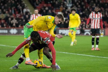 Femi Seriki of Sheffield United   protects the ball under pressure from a challenge from Oscar Schwartau of Norwich City during the Sky Bet Championship match Sheffield United vs Norwich City at Bramall Lane, Sheffield, United Kingdom 