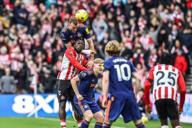 Dan Burn of Newcastle United jumps up to win the high ball during the Premier League match Sunderland vs Newcastle United at Stadium Of Light, Sunderland, United Kingdom, 14th December 2025
