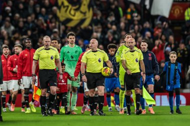 Referee Simon Hooper leads out the teams for the game during the Premier League match Manchester United vs Bournemouth at Old Trafford, Manchester, United Kingdom, 15th December 2025