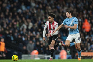 Kevin Schade of Brentford and Abdukodir Khusanov of Manchester City battle for the ball during the Carabao Cup Quarter Final match Manchester City vs Brentford at Etihad Stadium, Manchester, United Kingdom, 17th December 2025