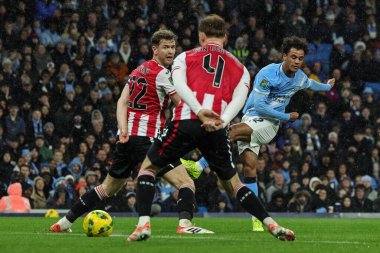 Oscar Bobb of Manchester City shoots on goal  during the Carabao Cup Quarter Final match Manchester City vs Brentford at Etihad Stadium, Manchester, United Kingdom, 17th December 2025