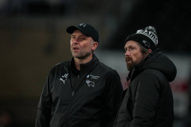Derby County 'nin John Eustace teknik direktörü 1 Ocak 2026' da İngiltere 'nin Pride Park Stadyumu' nda oynanan Derby County ve Middlesbrough arasındaki Sky Bet Şampiyonası maçına bakıyor.