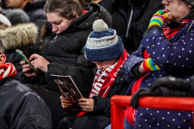 A young Nottingham Forest fan reads the match day programme during the Premier League match Nottingham Forest vs Everton at City Ground, Nottingham, United Kingdom, 30th December 2026