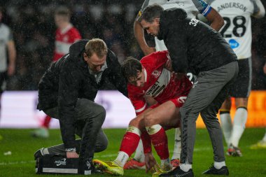 Callum Brittain of Middlesbrough is helped off the field after suffering an injury during the Sky Bet Championship match Derby County vs Middlesbrough at Pride Park Stadium, Derby, United Kingdom, 1st January 2026