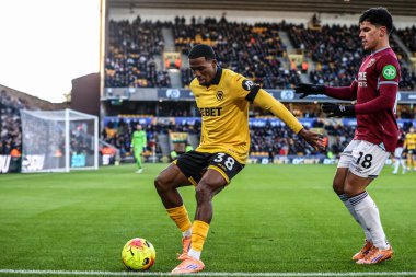 Jackson Tchatchoua of Wolverhampton Wanderers holds off Mateus Fernandes of West Ham United during the Premier League match Wolverhampton Wanderers vs West Ham United at Molineux, Wolverhampton, United Kingdom, 3rd January 2026