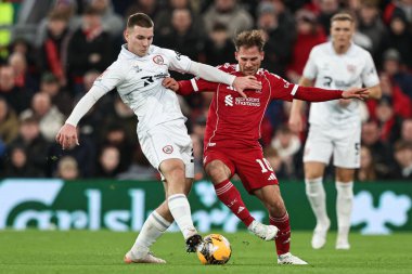 Barnsley 'den Jonathan Bland, Liverpool' lu Alexis Mac Allister 'dan, 12 Ocak 2026 tarihinde Liverpool, Liverpool, İngiltere' de Liverpool 'a karşı oynanan Liverpool FA Cup üçüncü tur karşılaşmasında topu alıyor.
