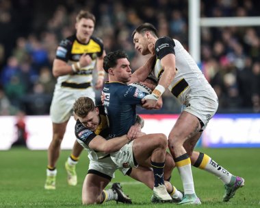Brodie Croft of Leeds Rhinos is tackled by Sam Wood and Liam Harris of York Knights during the Betfred Super League Round 2 match Leeds Rhinos vs York Knights at AMT Headingley Stadium, Leeds, United Kingdom on 20 February 2026
