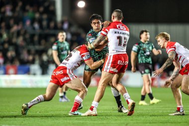 Joe Ofahengaue of Leigh Leopards is tackled by Shane Wright of St Helens and David Klemmer of St Helens during the Betfred Super League match St Helens vs Leigh Leopards at The BrewDog Stadium, St Helens, United Kingdom on 20 February 2026