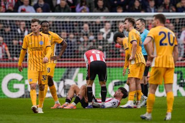 Aaron Hickey of Brentford receives treatment after an injury and is substituted off following an injury during the Premier League match Brentford vs Brighton & Hove Albion at GTECH Community Stadium, London, United Kingdom on 21 February 2026