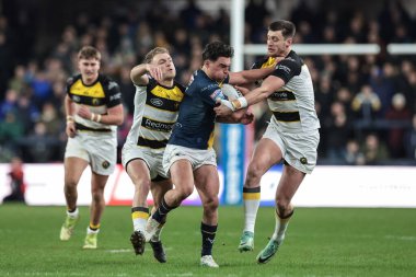 Brodie Croft of Leeds Rhinosis tackled by Sam Wood of York Knights during the Betfred Super League Round 2 match Leeds Rhinos vs York Knights at AMT Headingley Stadium, Leeds, United Kingdom on 20 February 2026