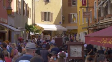 Annecy, Fransa - 1 Mayıs 2021: Fransa 'nın Annecy 2021' deki eski Fransız caddesinde birçok insan bahar veya yaz aylarında güneşli bir günde dışarıda maskeli insanlar. Restoran, bar ve kahve evi..