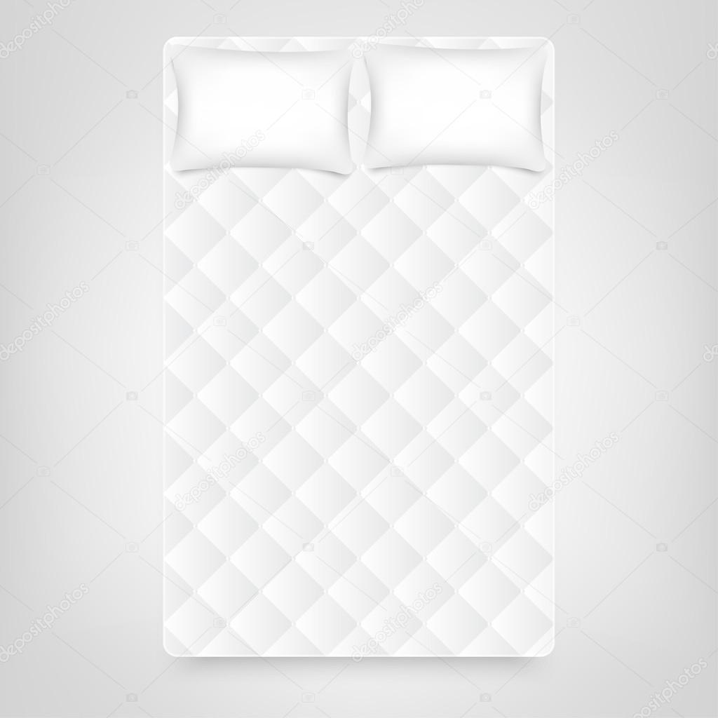 wo pillows on white mattress