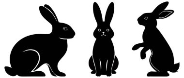 Oturma ve ayakta duran siyah tavşan siluetleri beyaz arka planda izole edilmiş, Paskalya, bahar temaları veya tasarım projeleri için ideal