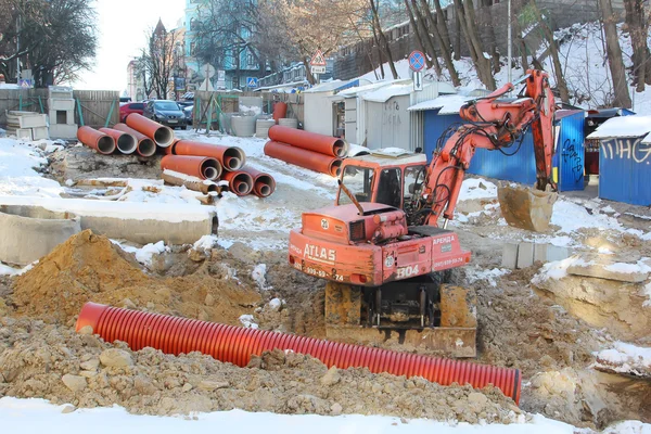 Kiev, UKRAINE - 17 February 2015: The roadway, excavator leads r Royalty Free Stock Photos