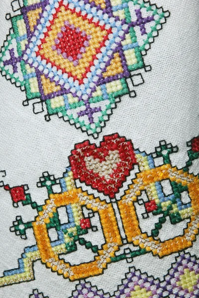 Red heart embroidered handmade with a cross — Stock Photo, Image