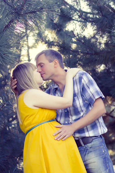 Happy and young pregnant couple on nature — Stock Photo, Image