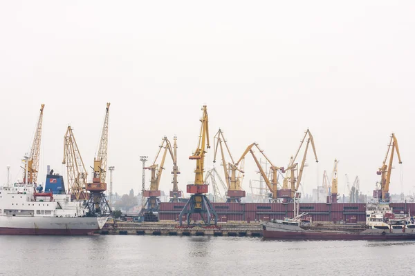 Commerciële haven van Ilyichevsk. Het laden van een vrachtschip op dock in Odessa zeehaven. Gemechaniseerde metalen werkwagen — Stockfoto