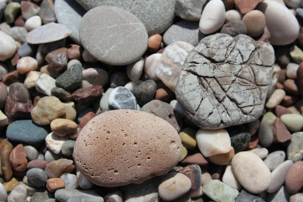 Abstrakter Hintergrund mit Kieselsteinen - runde Meeressteine — Stockfoto