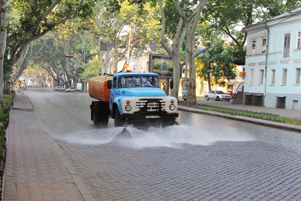 Watering the streets in the morn
