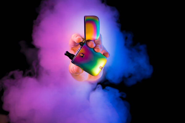 Photograph of a hand with a vaper.
