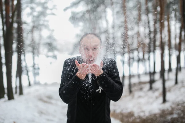 Groom blowing snow off his hands — Stock Photo, Image