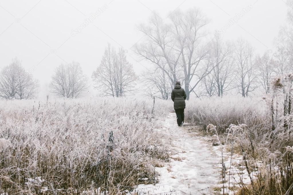 Woman walking in fog