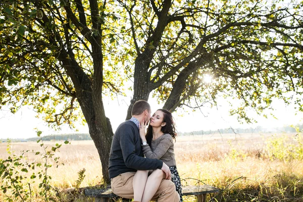 Young couple hugging at autumn sunset — Stock Photo, Image