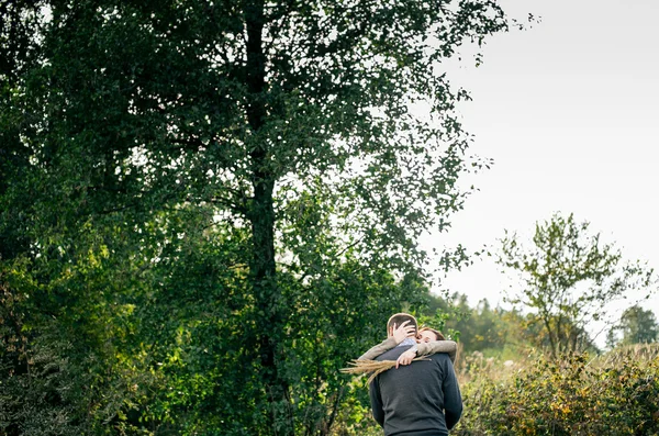 Young couple hugging in a forest — Stock Photo, Image