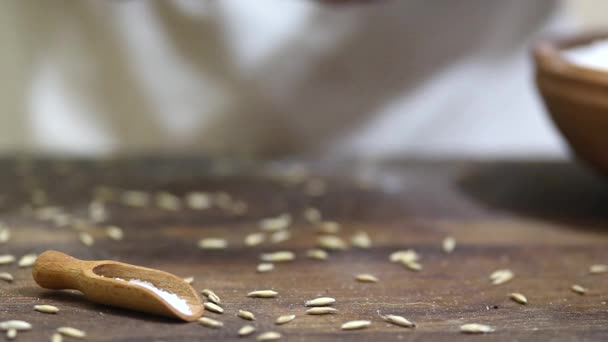 Baker gently putting freshly baked loaf of homemade organic sourdough rye bread down on wooden table and covering it with cotton cloth — Stock Video