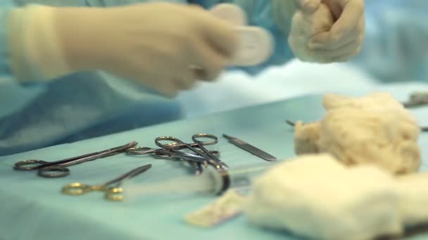 Tray with surgical instruments and used gauze swabs during surgery — Stock Video