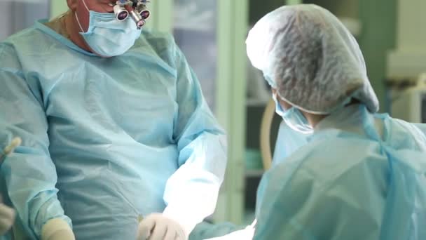 Surgeon performing cosmetic surgery on breasts in hospital operating room. Mammoplasty — Stock Video