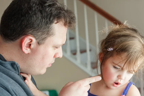 Preschool age little girl getting spoken to by her father. — Stock Photo, Image
