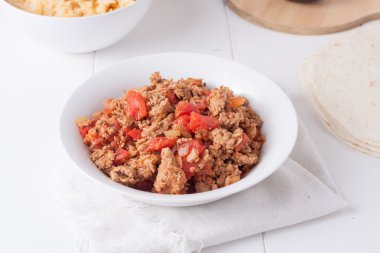 fried ground meat with tomatoes ready for tacos clipart
