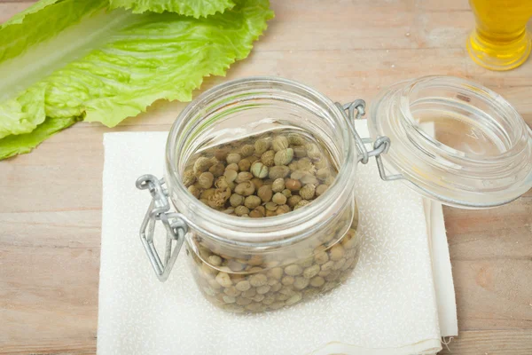 Capers in glass jar — Stock Photo, Image