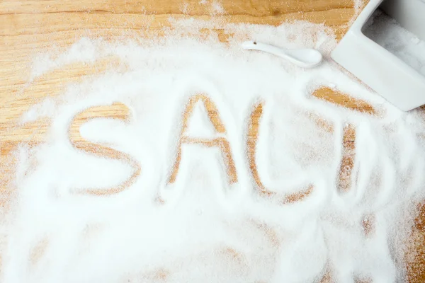 Words SALT handwritten on salt — Stock Photo, Image