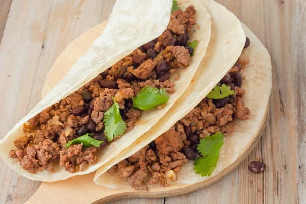 Two meat tacos with black beans garnished with cilantro — Stock Photo, Image