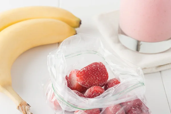 Frozen strawberries in clear plastic bag — Stock Photo, Image