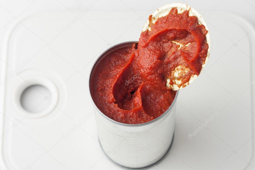 Opened can of tomato paste