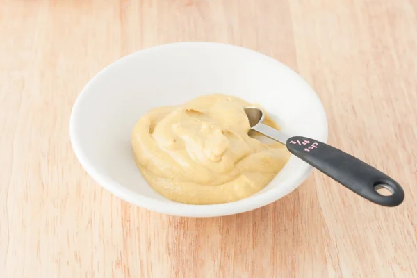 Mustard on wooden background — Stock Photo, Image