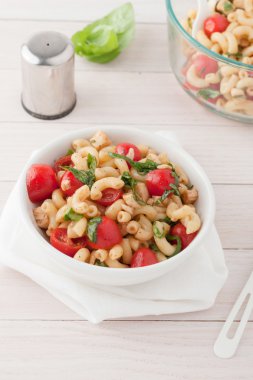 Italian macaroni salad with tomatoes and fresh basil