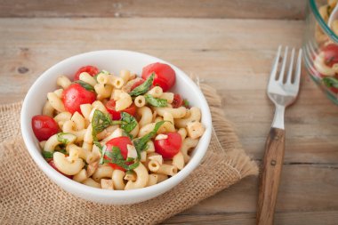 Italian macaroni salad with tomatoes and fresh basil