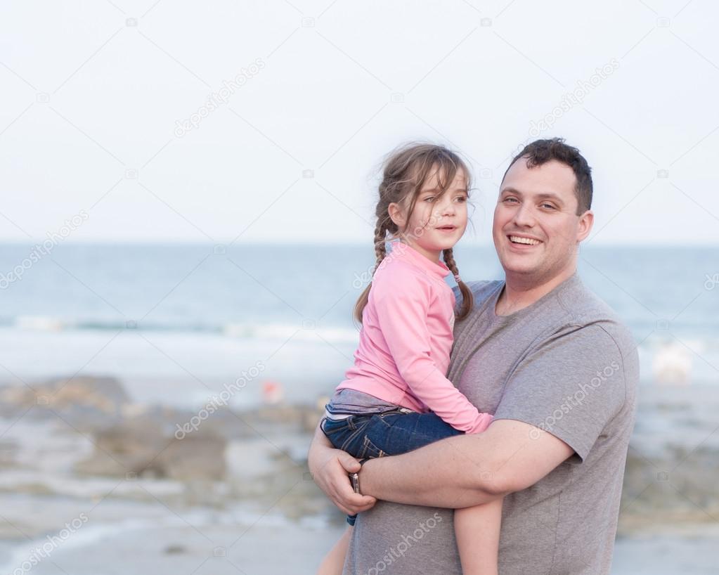 happy single parent holding his daughter