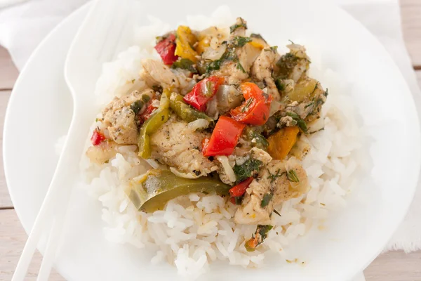 Chicken or pork with peppers and herbs and spices over rice — Stock Photo, Image