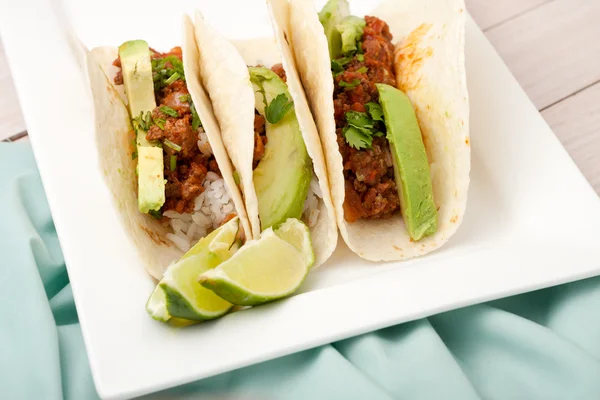 Three homemade soft tacos with ground meat, avocados, cilantro and rice — Stock Photo, Image