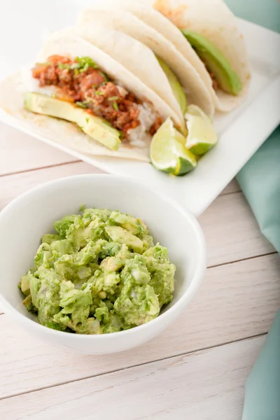 Three homemade soft tacos with ground meat, avocados, cilantro and rice — Stock Photo, Image