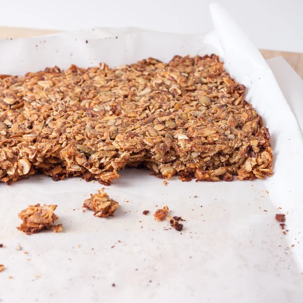 Verse zelfgemaakte muesli bars gemaakt met kokosolie, noten en zaden op een bakplaat — Stockfoto