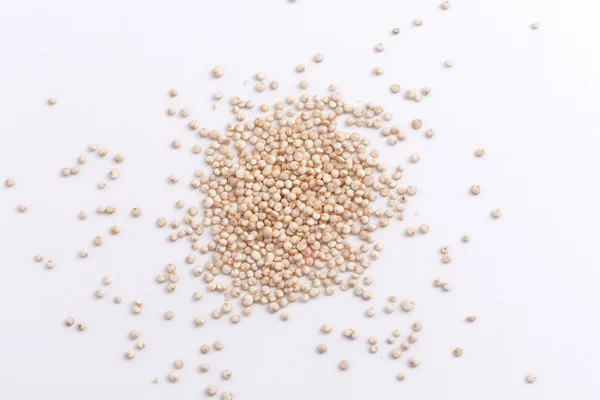 White quinoa seeds scattered on white background — Stock Photo, Image